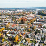 Aerial overview of the Westlake neighborhood, which resides along Lake Union. In the far background is the University of Washington and Lake Washington.