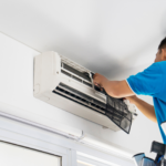 Air conditioning technician repairing an electric air conditioning system at home