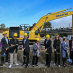people in hard hats smiling with shovels at the Mount Baker Redevelopment groundbreaking event