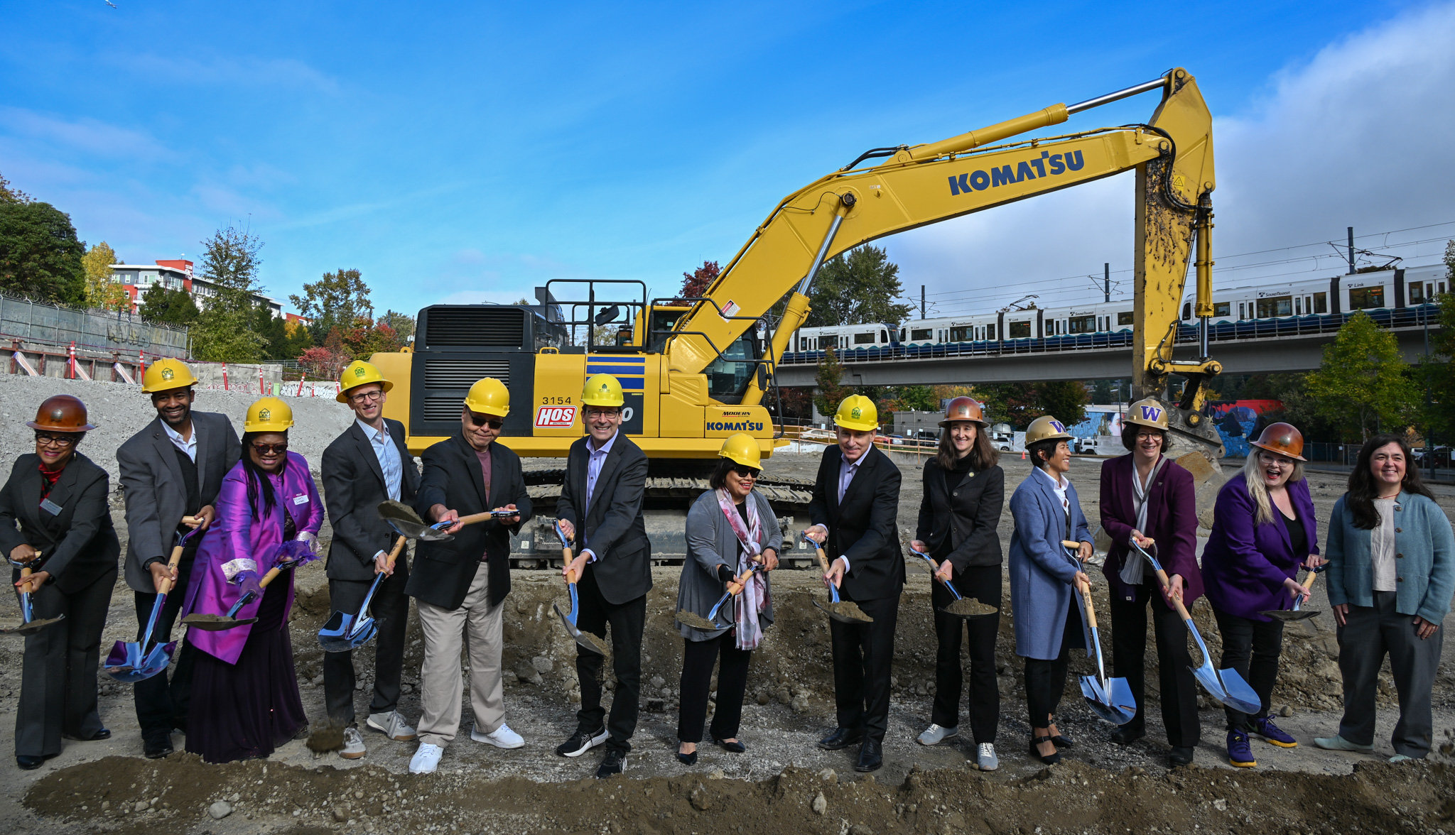 people in hard hats smiling with shovels at the Mount Baker Redevelopment groundbreaking event